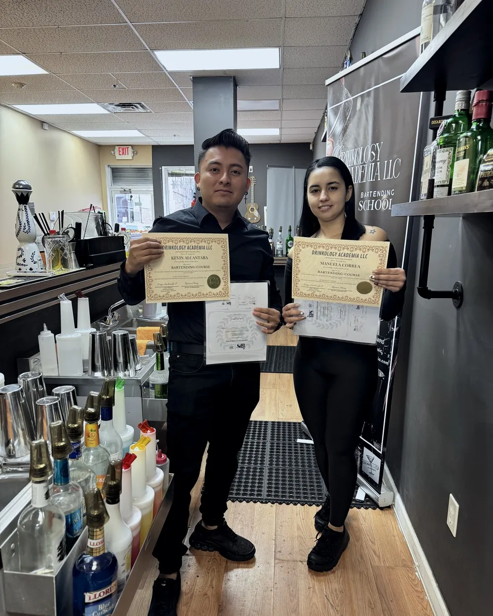 Dos graduados con sus certificados